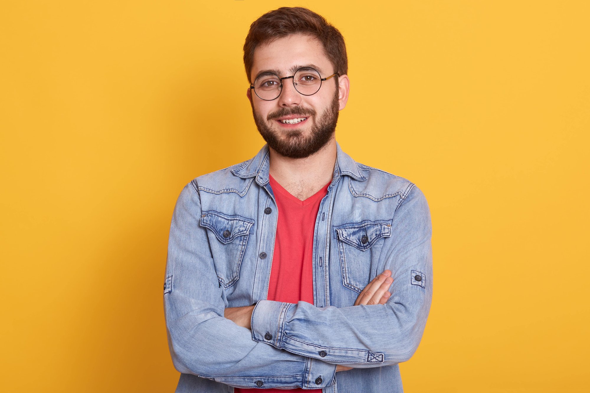 indoor-picture-cheerful-handsome-young-man-having-folded-hands-looking-directly-smiling-sincerely-wearing-casual-clothes-min
